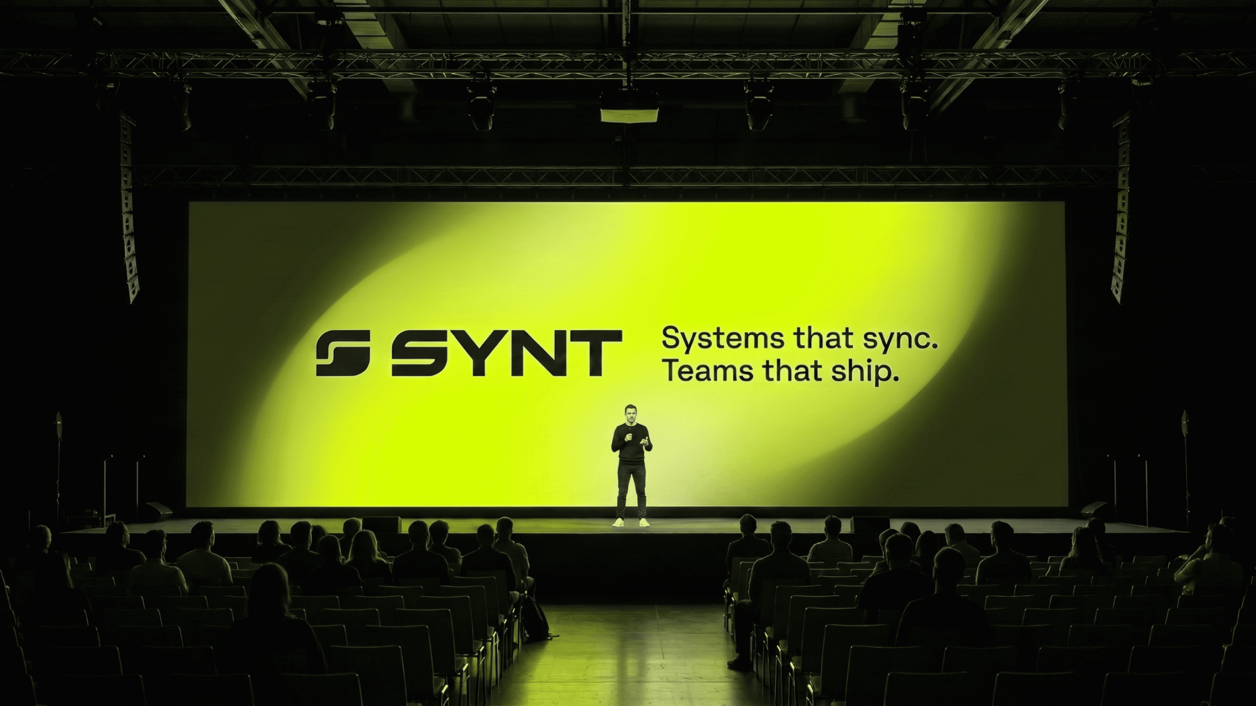 SYNT logo displayed on stage screen during presentation event