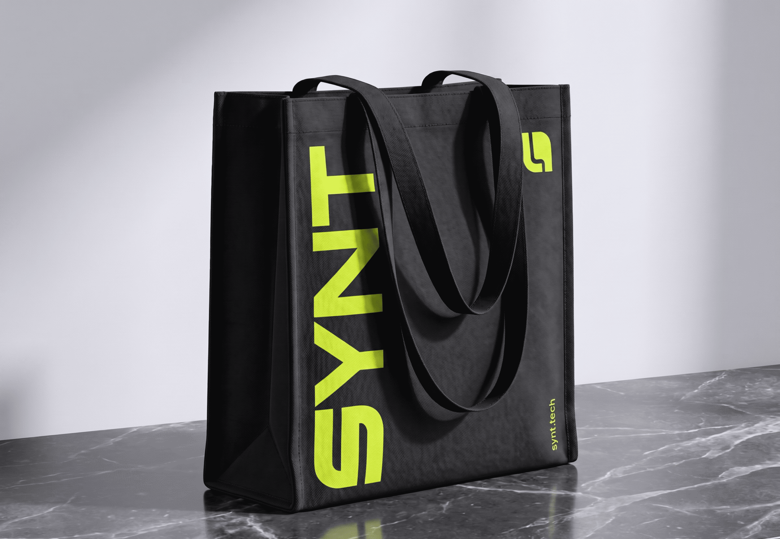 SYNT branded black tote bag with yellow logo design
